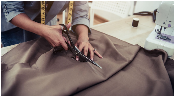 Photo of a tailor cutting cloths